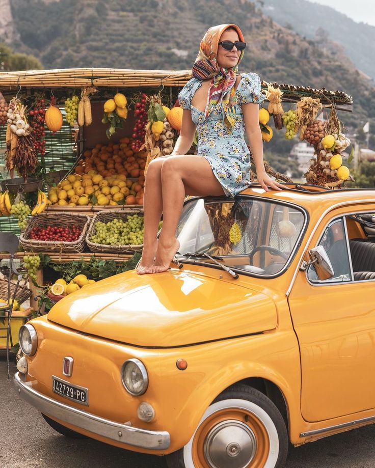 Woman on Yellow Fiat with Fruit Stall