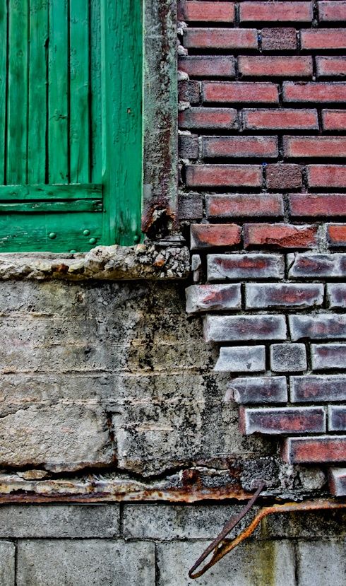 Weathered Brick Wall with Green Shutters