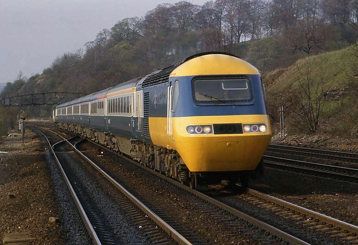 Yellow and Blue Train on Tracks