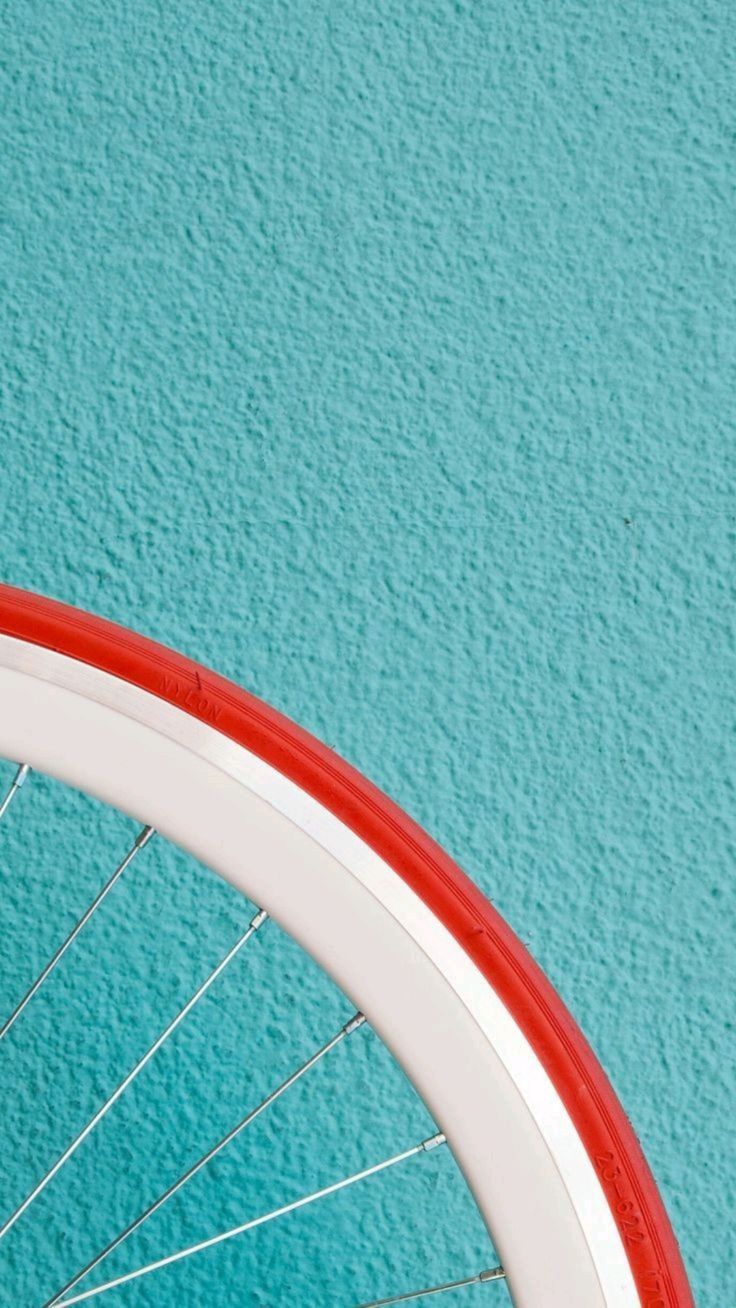 Bicycle Wheel against Turquoise Wall
