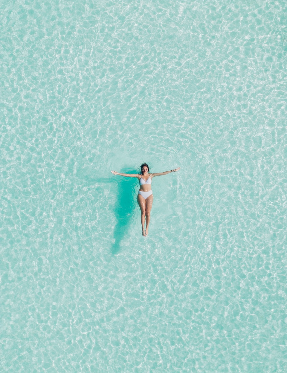 Woman Relaxing in Crystal Clear Water