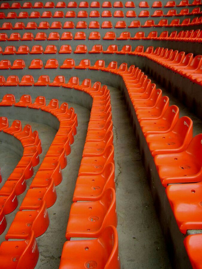 Rows of orange stadium seats