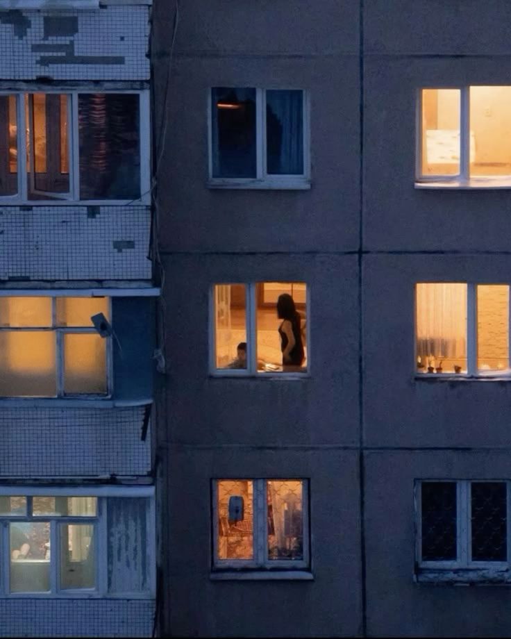 Silhouetted Figure in Dimly Lit Apartment
