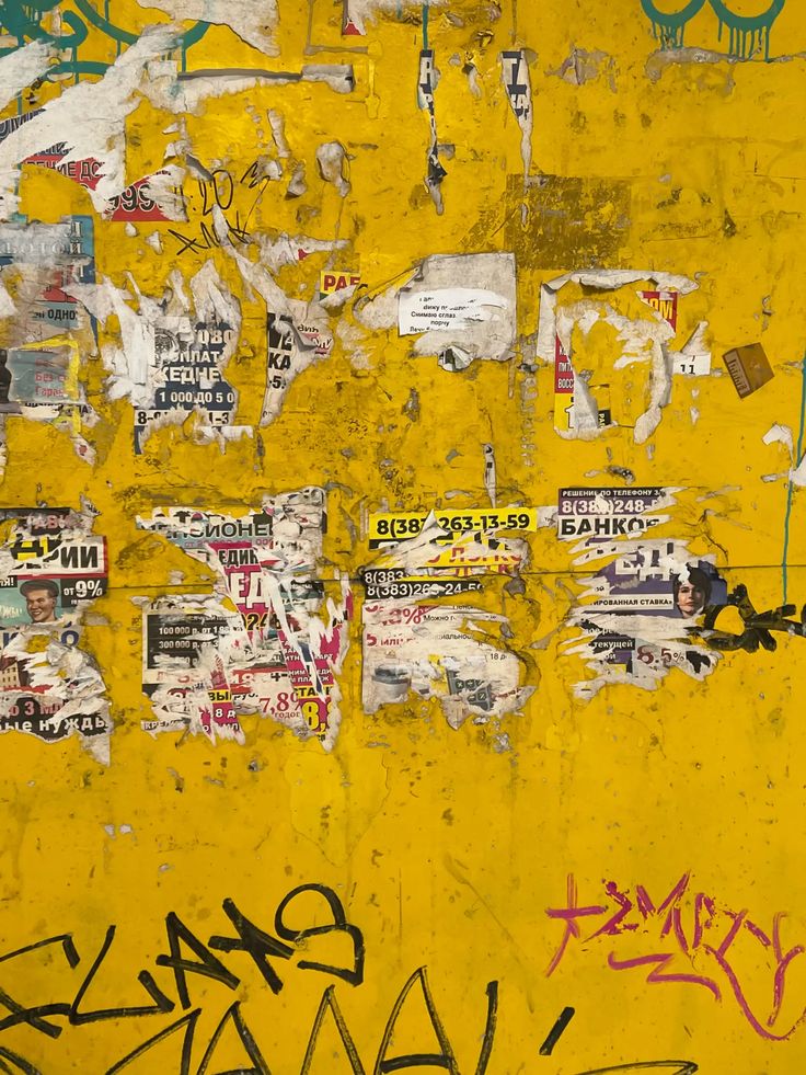 Weathered Yellow Wall with Graffiti