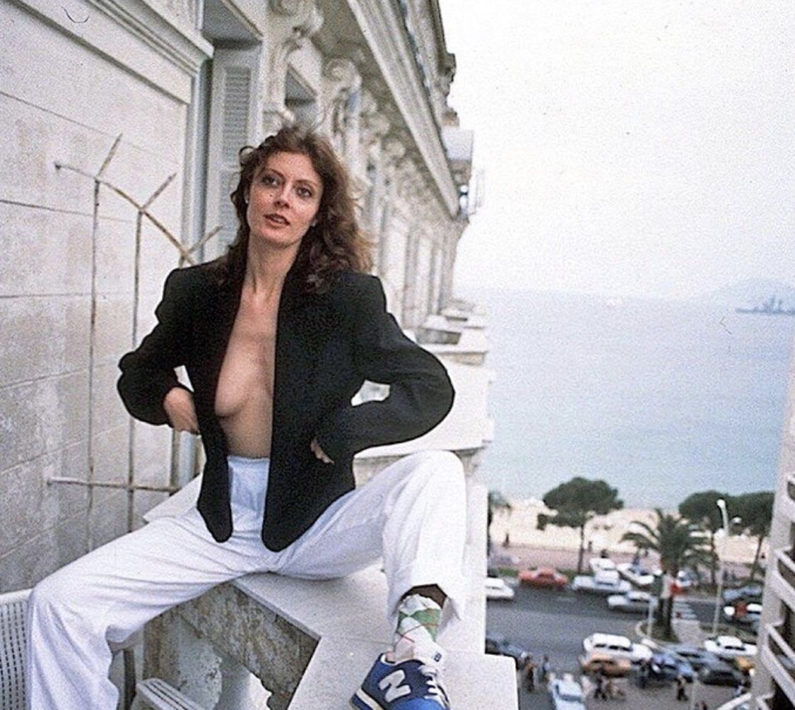 Woman in White Suit on Balcony