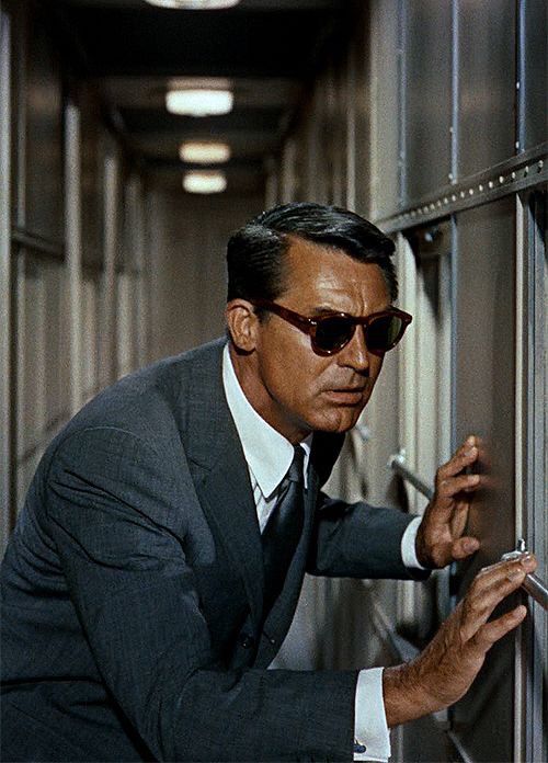 Man in Suit Peering Through Bars