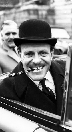 Smiling man in top hat smoking pipe