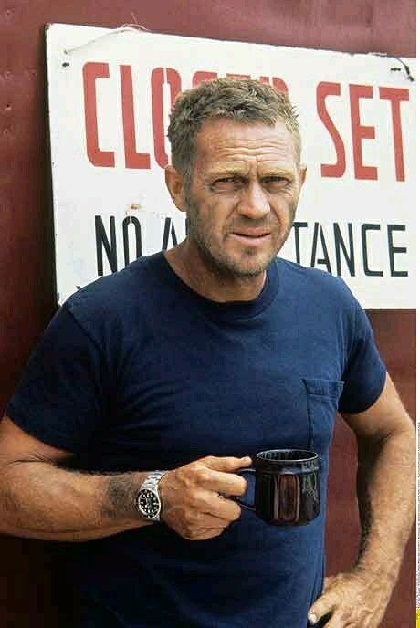 Man Holding Mug Near 'No Assistance' Sign