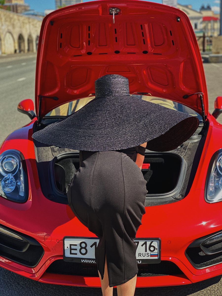 Person in Hat Inside Car Trunk