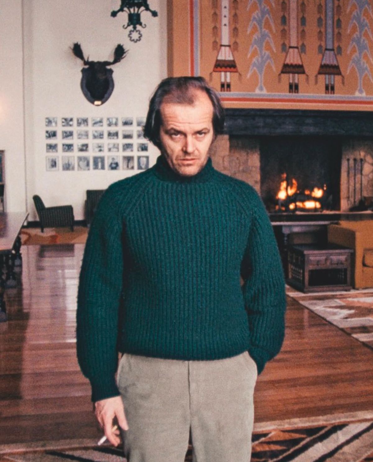 Man in Green Sweater by Fireplace