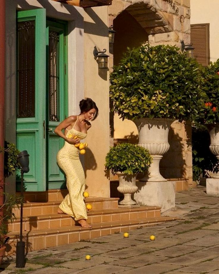 Woman in Yellow Dress Climbing Steps
