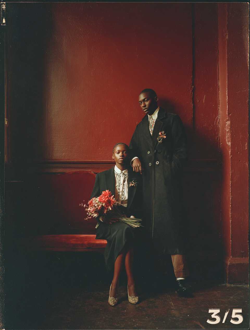 Formal Couple Against Red Wall