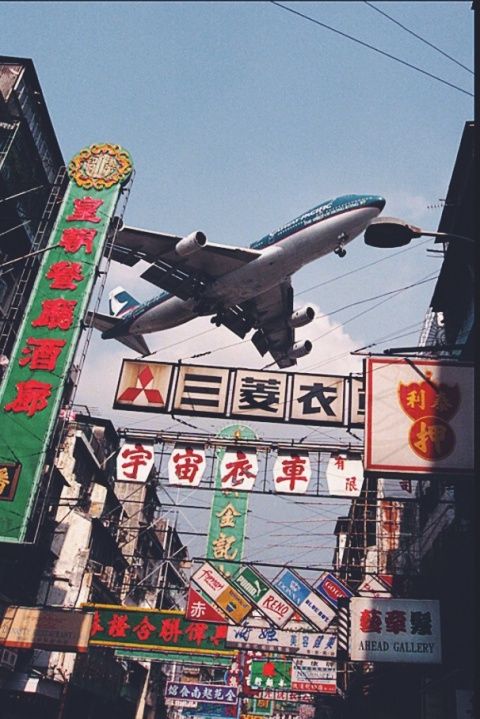 Airplane Over Urban Signage