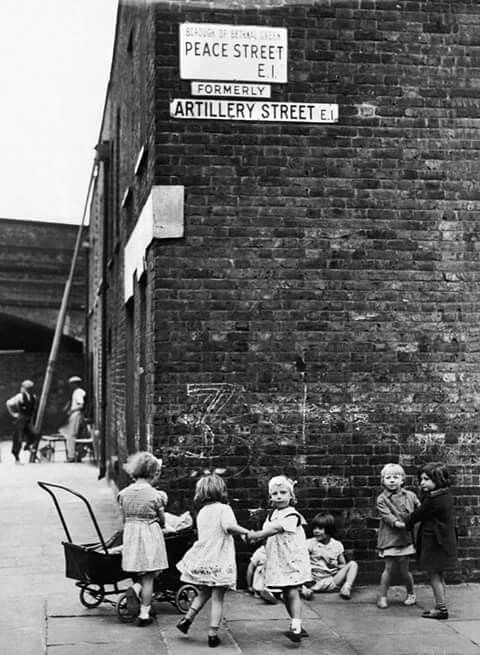 Children playing in front of brick wall