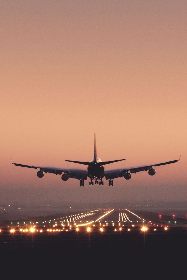 Airplane Landing at Sunset