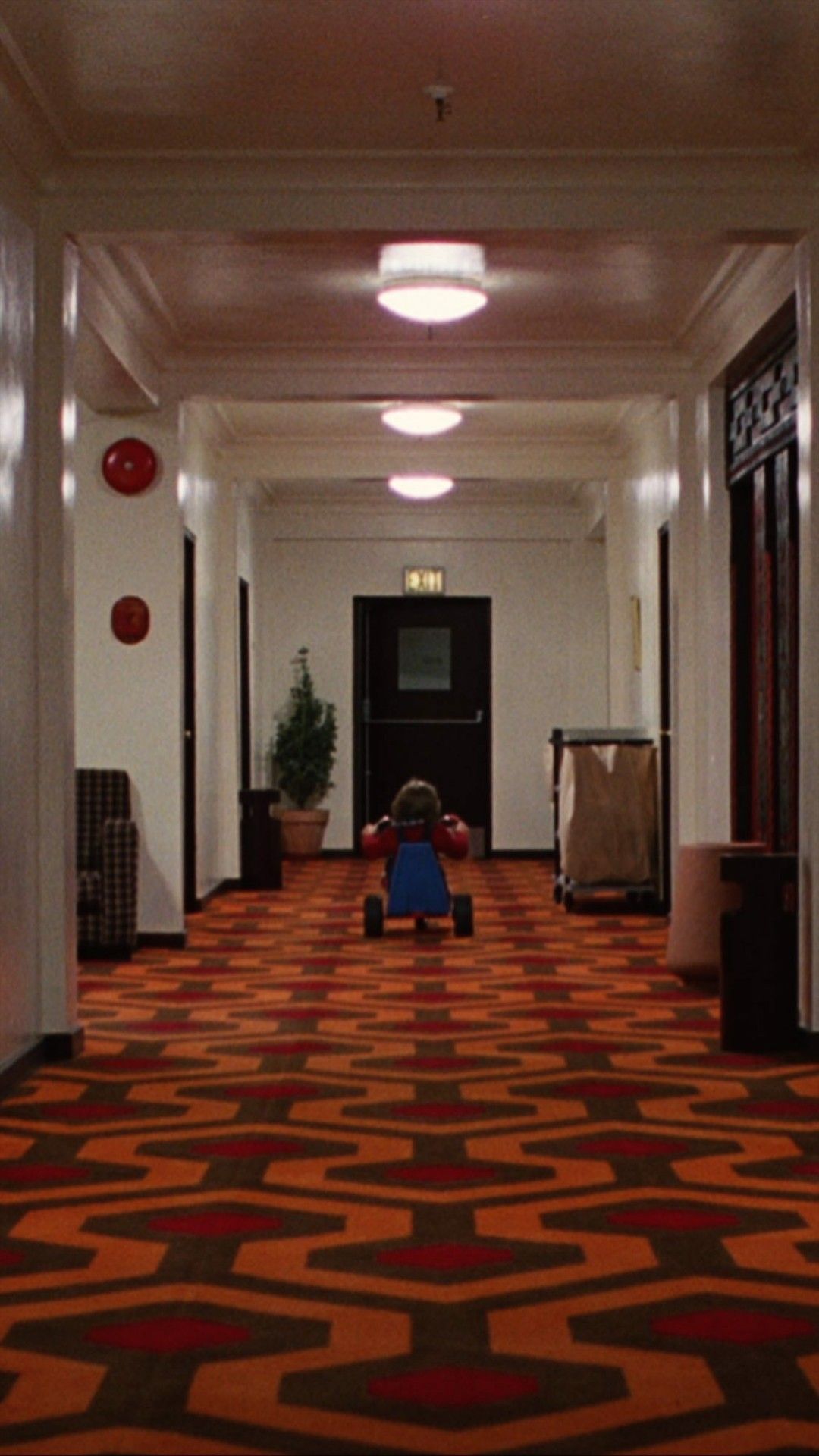 Child on Tricycle in Hotel Corridor