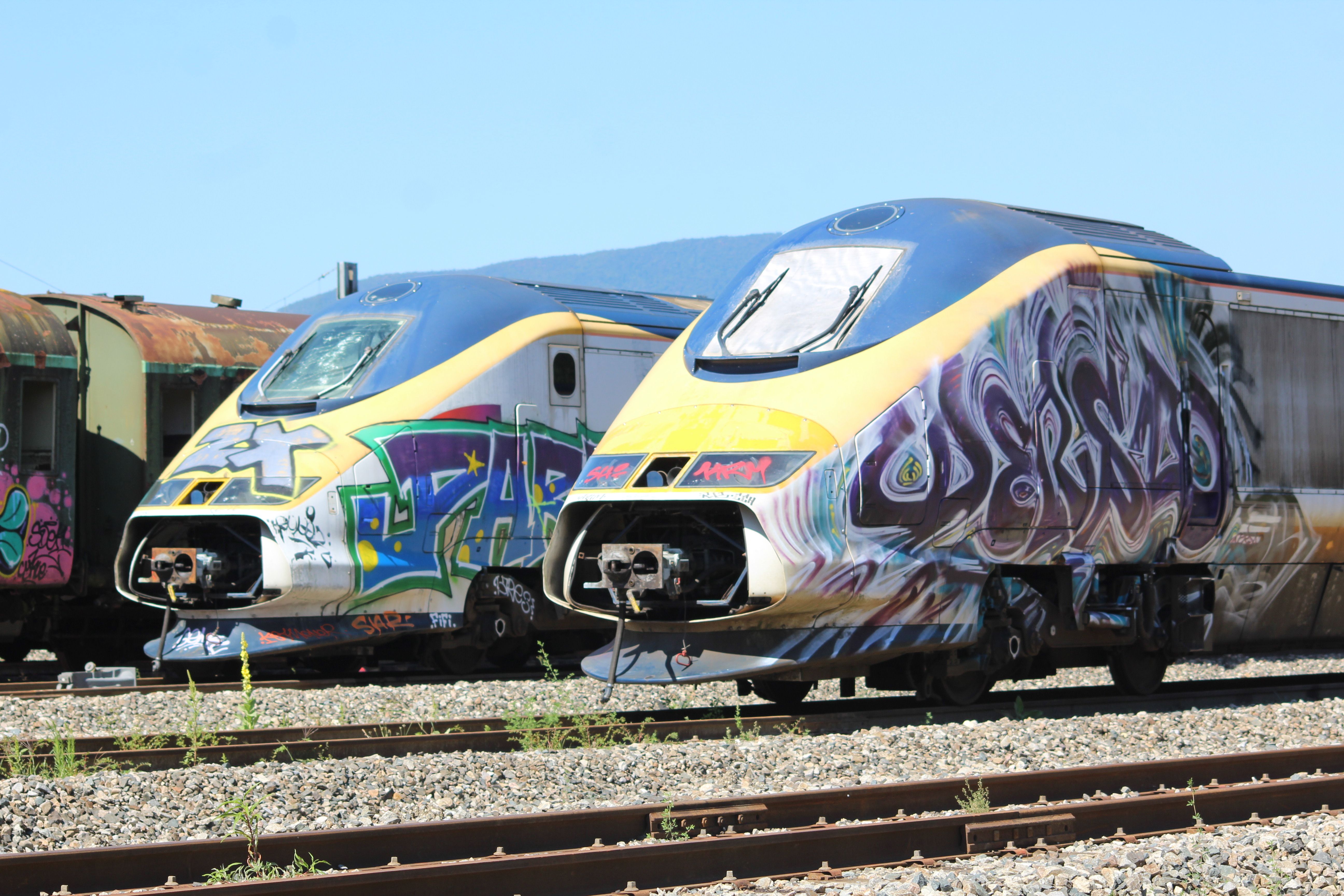 Graffiti-covered trains on tracks