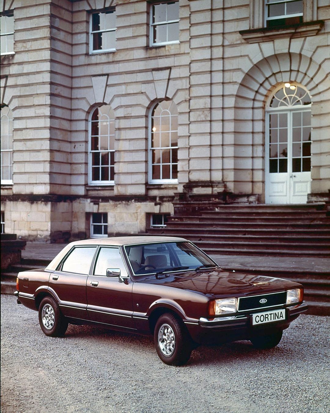 Ford Cortina parked outside grand building