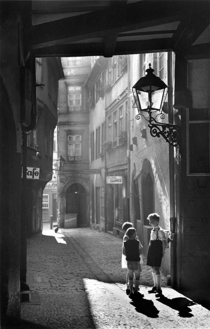Children in a cobblestone alley