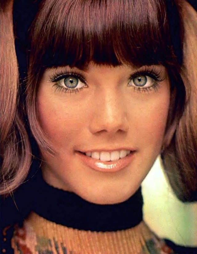 Close-up of a smiling woman with bangs