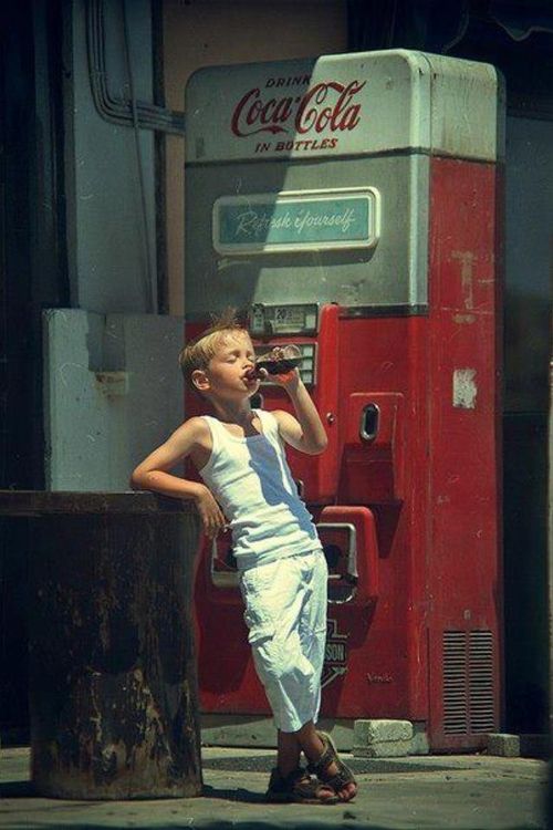 Boy Drinking from Vintage Soda Machine