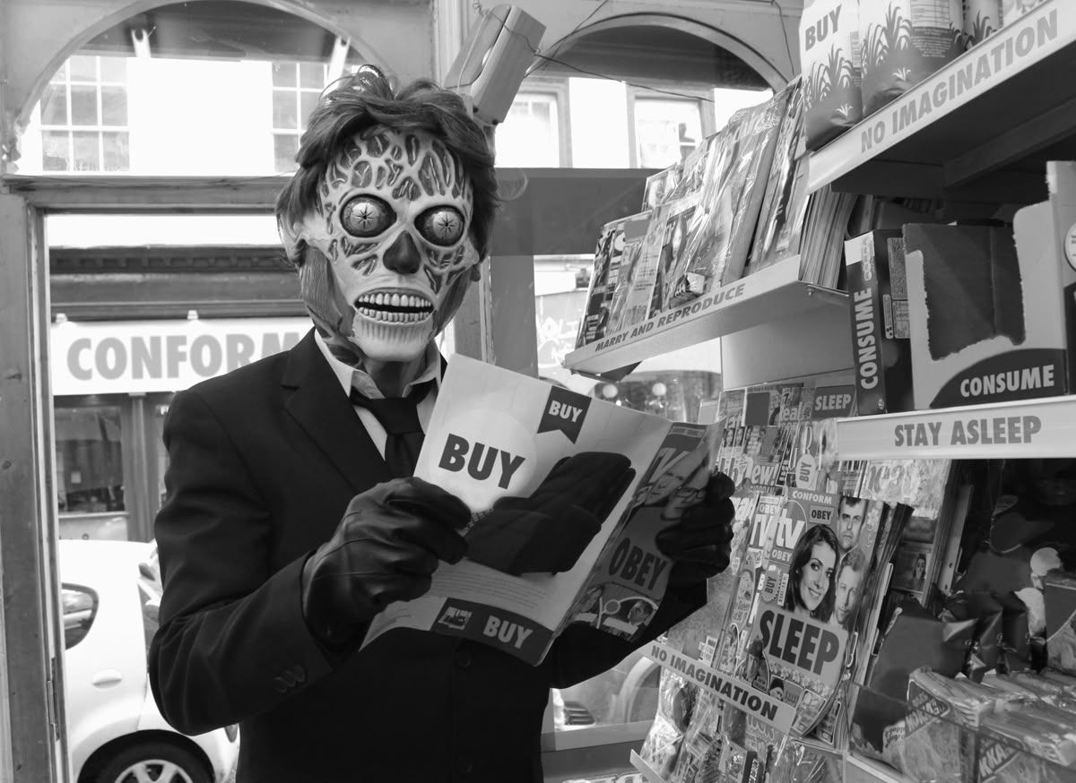 Masked figure reading 'BUY' magazine