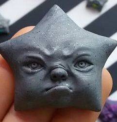 Star-Shaped Clay Sculpture of a Dog Face