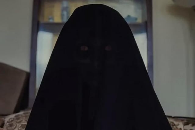 Silhouette of a hooded figure