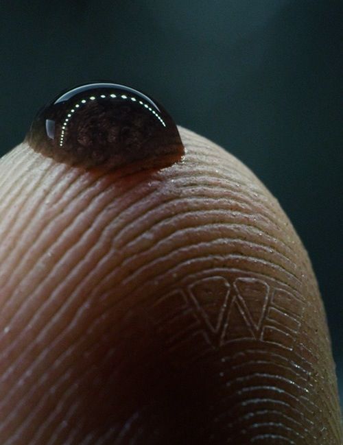 Close-Up of a Thumb with a Water Drop