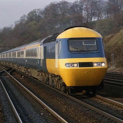 Yellow and Blue Train on Tracks