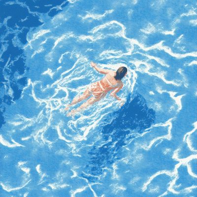Woman Floating in Blue Ocean