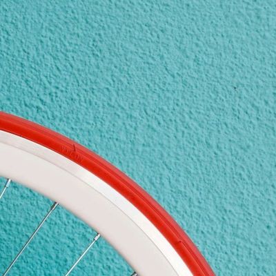 Bicycle Wheel against Turquoise Wall