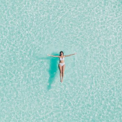 Woman Relaxing in Crystal Clear Water