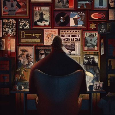 Man in Chair Surrounded by Vintage Ads