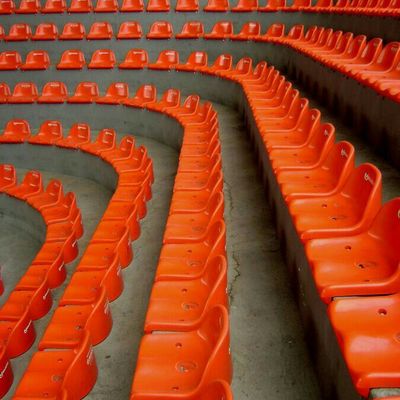Rows of orange stadium seats