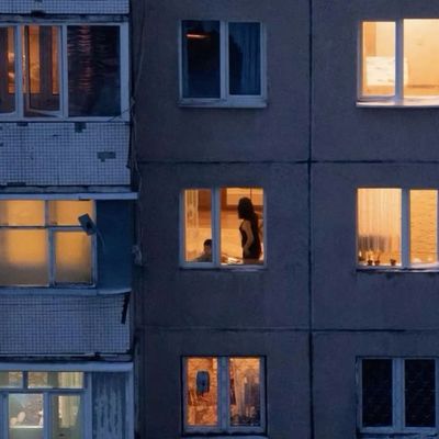 Silhouetted Figure in Dimly Lit Apartment