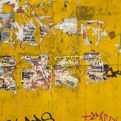 Weathered Yellow Wall with Graffiti