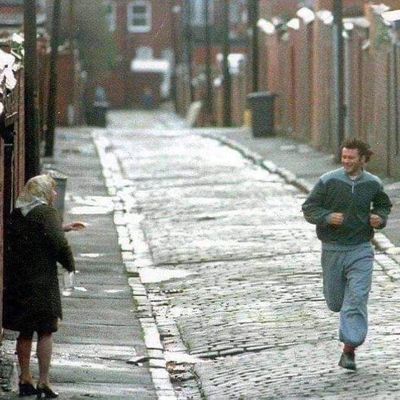 Man jogging past elderly woman