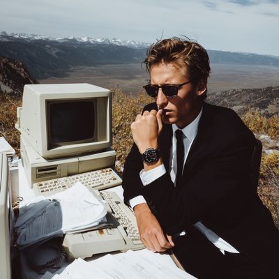 Man in suit at computer in scenic location