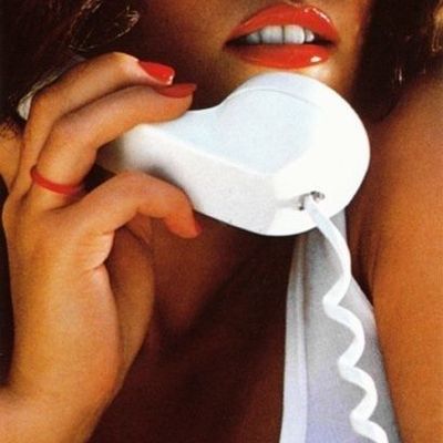 Woman with red nails holding a white object