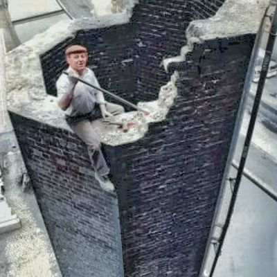Man climbing brick wall