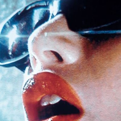 Close-up of glossy lips and sunglasses