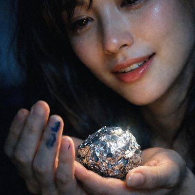 Woman holding foil-wrapped object