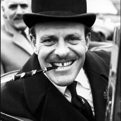 Smiling man in top hat smoking pipe