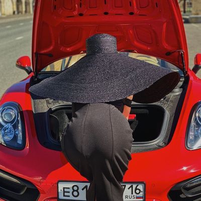 Person in Hat Inside Car Trunk