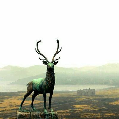Epic Stag Statue Overlooking Misty Landscape