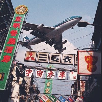 Airplane Over Urban Signage