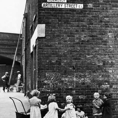 Children playing in front of brick wall