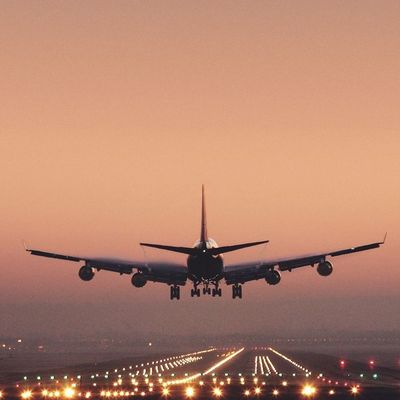 Airplane Landing at Sunset