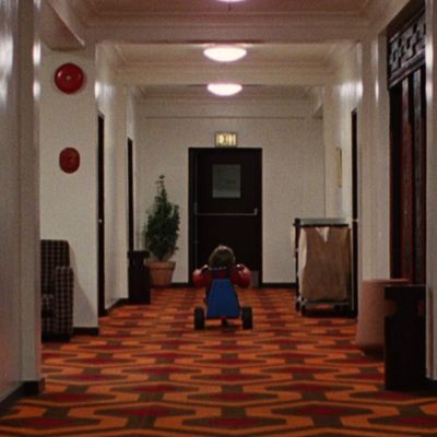 Child on Tricycle in Hotel Corridor